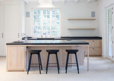 Lichte eiken fineer modern klassieke keuken op maat met kookeiland en zwart natuursteen blad